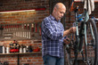 © guerrieroale - Mechanic working on a bicycle during servicing