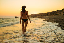 Young Sexy Caucasian Woman Walking Along Ocean Beach