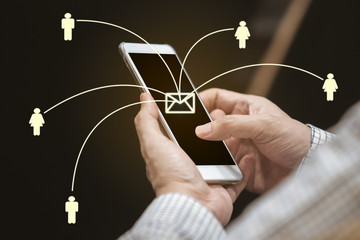close up hand of man using smartphone sending message from E-mail to other people with network. contact concept.