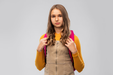 Sticker - high school, education and people concept - smiling teenage student girl with backpack over grey background