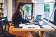 © BullRun - Stylish woman working on laptop in office
