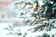 Christmas Tree Outdoor With Snow, Lights Bokeh Around, And Snow Falling, Christmas Atmosphere.