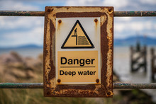 Sign: Danger, Deep Water - With Blurry Background, Seen In Silloth, Cumbria, England, UK