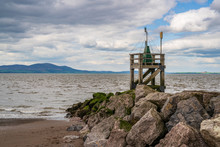 The Entrance To The Harbour With The Coast Of Scotland In The Background, Seen From The West Beach In Silloth, Cumbria, England, UK