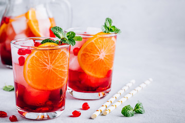 Wall Mural - Pomegranate Orange Holiday Punch with ice and mint in glass