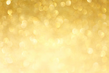 Golden Sparkle Glitters With Bokeh Effect And Selectieve Focus. Festive Background With Bright Gold Lights, Champagne Bubble. Christmas Mood Concept. Copy Space, Close Up, Texture, Top View.