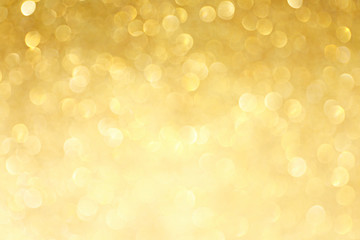 golden sparkle glitters with bokeh effect and selectieve focus. festive background with bright gold 