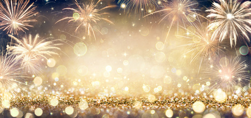 Wall Mural - golden glitter background with fireworks in the night