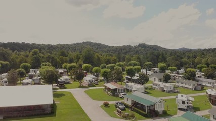 zooming over the top of a campground and trailers to the river drone
