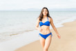 © AntonioDiaz - Cheerful Woman In Swimsuit Walking At Beach