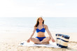 © AntonioDiaz - Woman In Bikini Performing Yoga At Beach