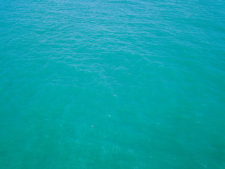 Aerial view of turquoise waves, water surface texture. Thailand