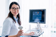 © InsideCreativeHouse - Portrait of cheerful female doctor with ultrasound sensor
