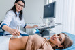 © InsideCreativeHouse - Portrait of woman getting ultrasound from doctor