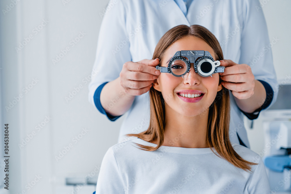 Female patient checking vision in ophthalmological clinic - obrazy, fototapety, plakaty 