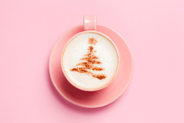 Top view of cup of latte with art in shape of Christmas tree