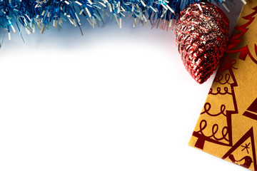 Christmas toy and card with tinsel on a white background