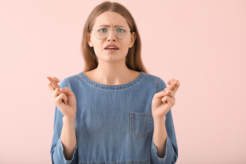 Sticker - Worried young woman on color background