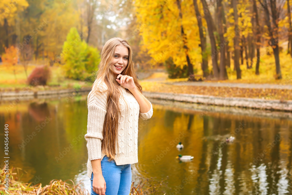 Beautiful young woman in autumn park