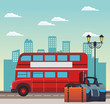 london bus and travel bags on the stree over urban city buildings scenary background