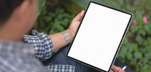 Cropped Shot Of Businessman Working On His Project With Blank Screen Tablet With Garden Background