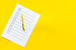 Empty check list ready to fill on yellow background top view space for text