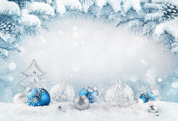 merry christmas background. blue christmas balls and baubles and wooden decorative tree on the snow 