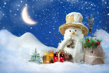 Wall Mural - Snowman in a snowdrift with gifts for Christmas and New year