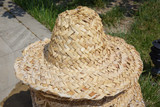 Fototapeta Lawenda - summer straw natural fiber weave caps . A basketry hat, top view . Hats from natural materials, reed leaves .