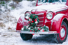 A Red Car With Christmas Decorations And Christmas Tree Is Standing In A Snowy Winter Forest. Festive New Year Concept.