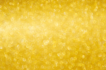 Wall Mural - Golden shining glowing bokeh abstract texture for Christmas and festive design.