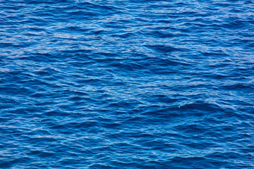 Blue expanse of water at sea as abstract background