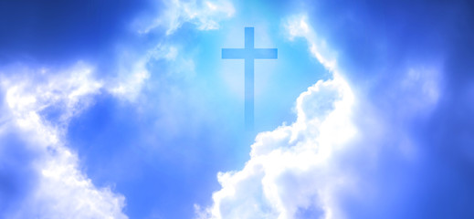 Christian cross appeared bright in the sky with soft fluffy clouds, white, beautiful colors. With the light shining as hope, love and freedom in the sky background