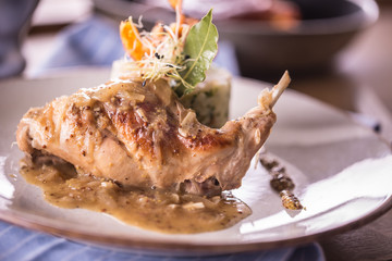 Wall Mural - Rabbit leg with mashes potatoes and decoration on plate in restaurant