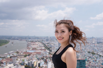 Wall Mural - Young asian woman relaxing after exercising on sunny day. Copy space in right side