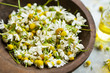 © marrakeshh - Dried chamomile flowers in wooden bowl