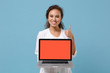 © ViDi Studio - African american doctor woman isolated on blue background. Doctor in medical gown hold laptop pc computer with blank screen showing thumb up. Healthcare personnel medicine concept. Mock up copy space.