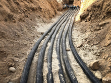 The High Voltage Electrical Cable Is Laid In A Trench