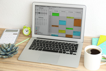 Wall Mural - Modern laptop with calendar app in office