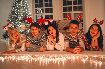 Wall Mural - Group of friends celebrating Christmas at home