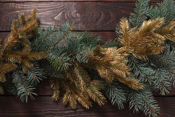 Christmas fir branches  on old dark wooden background