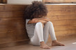 Upset biracial preschooler girl cry sitting on floor