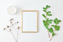 Flat Lay Composition With Golden Frame And Branches With Green Leaves On A Light Background