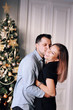 © Mariia - Beautiful young couple in Christmas. A young woman and a man are smiling and having fun together.