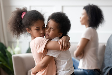 Wall Mural - Little african kids embracing passing through divorce of parents together