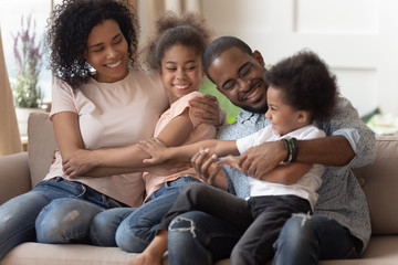 Wall Mural - Cheerful african family funny spending time together at home