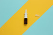nasal spray against a runny nose on a colored paper background. Medical mini still life