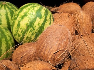 close-up of fresh tasty organic wholesome watermelons and brown coconuts