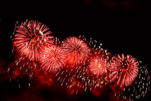 Flashes Of Red Fireworks Against Black Sky