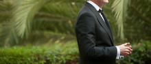 Elegant Man Dressed In Tuxedo For Fantastic Garden Wedding In The Background Predominantly Green